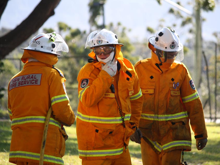 Three firefighters standing