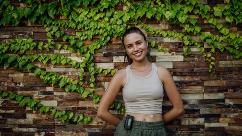 A girl with an insulin pump standing