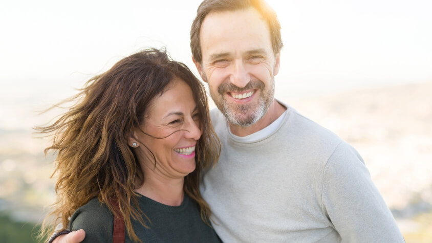 Man putting his arm around a woman