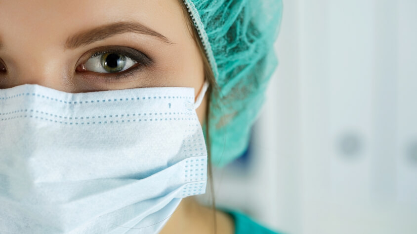A health professional wearing a surgical mask