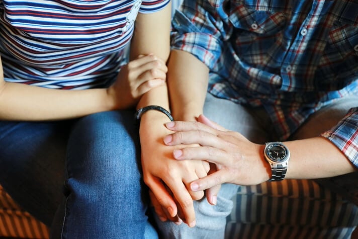 A man holding a woman's hand
