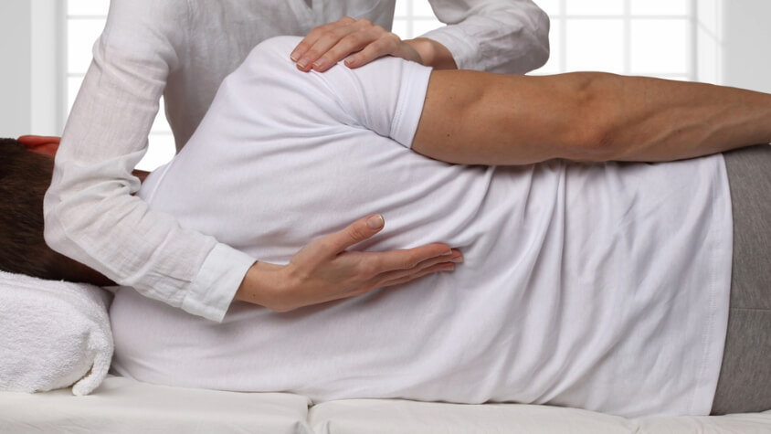 A man receives back treatment