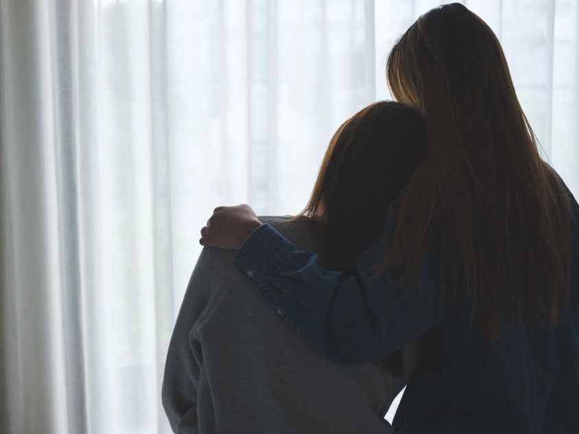 A woman consuls another woman