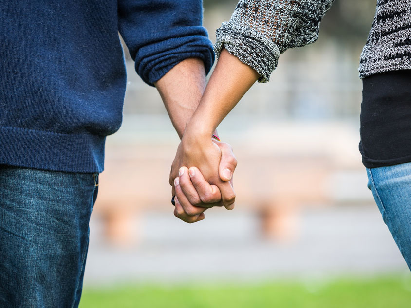 A man and a woman holding hands