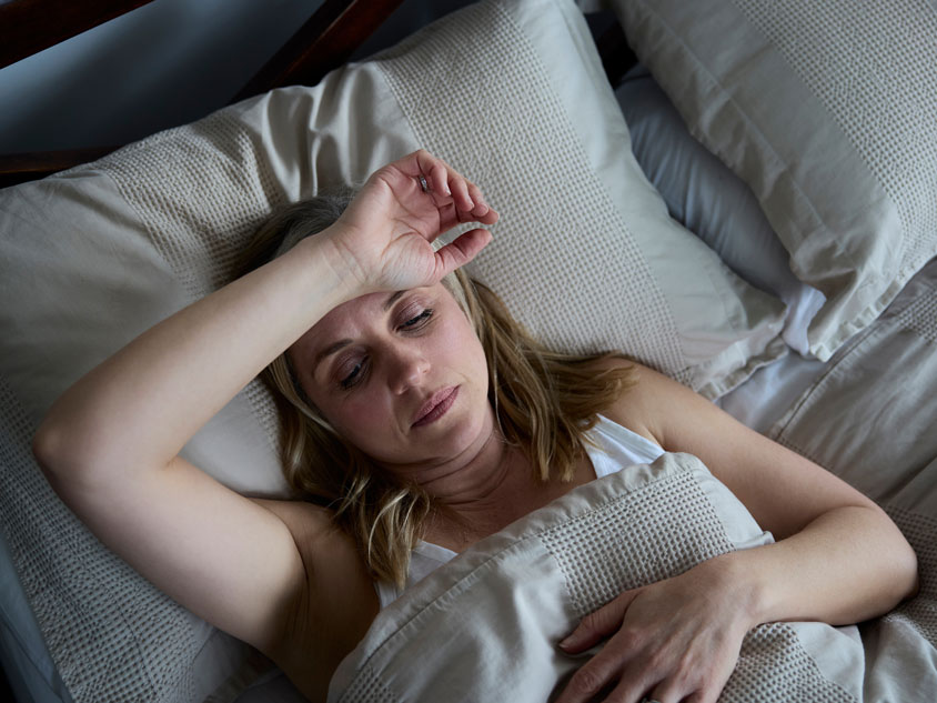 A woman sleeping on a bed