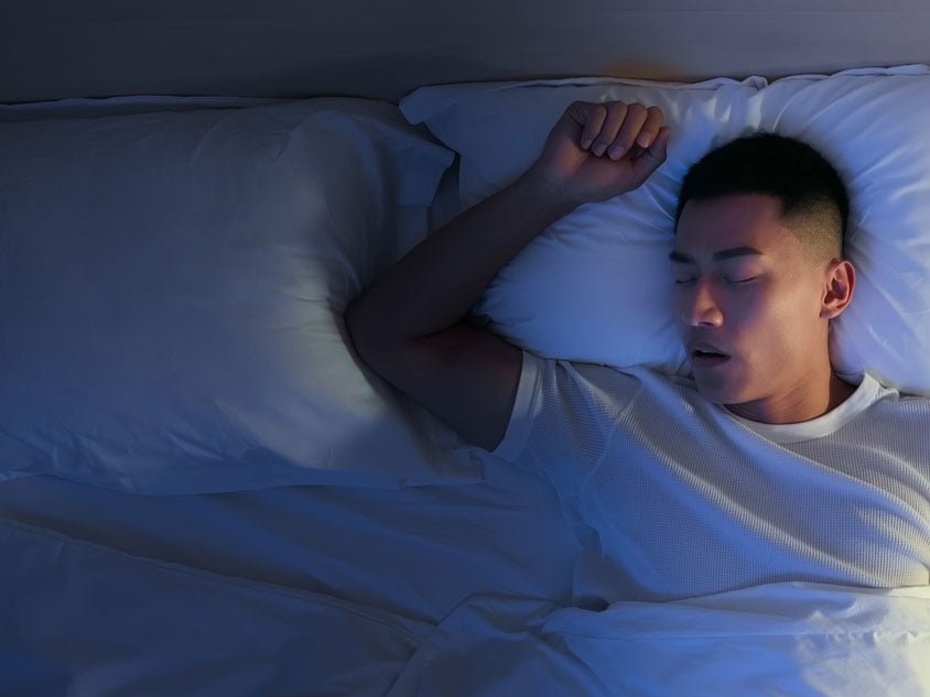 A man sleeping on a bed