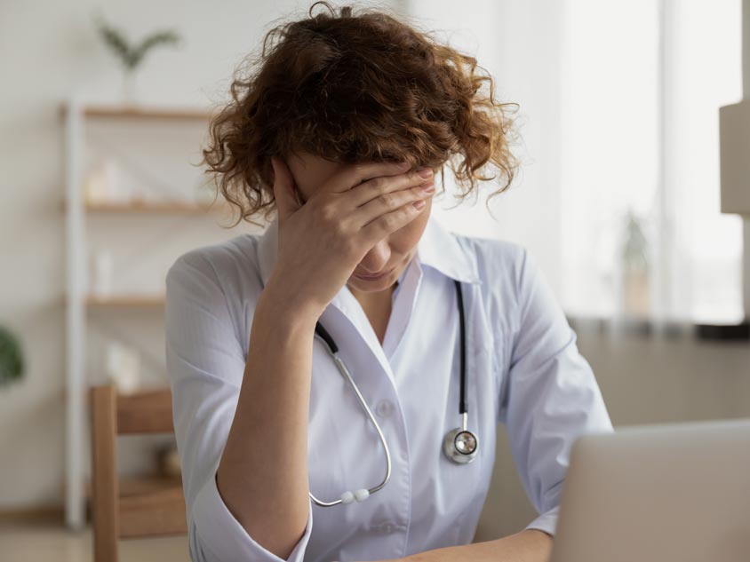 A health professional showing signs of stress