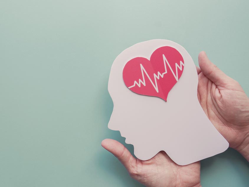 A cut out of a human head with a heart on it